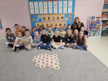 Dzieci z grupy „Malinki” uczestniczące w zajęciach z okazji Dnia Pszczoły – bawią się, uczą o pszczołach i degustują miód.